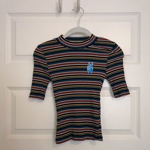 Striped mock-neck ribbed top with peace sign patch